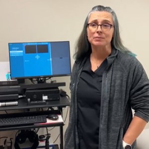 Dr. Myers standing in front of vestibular equipment