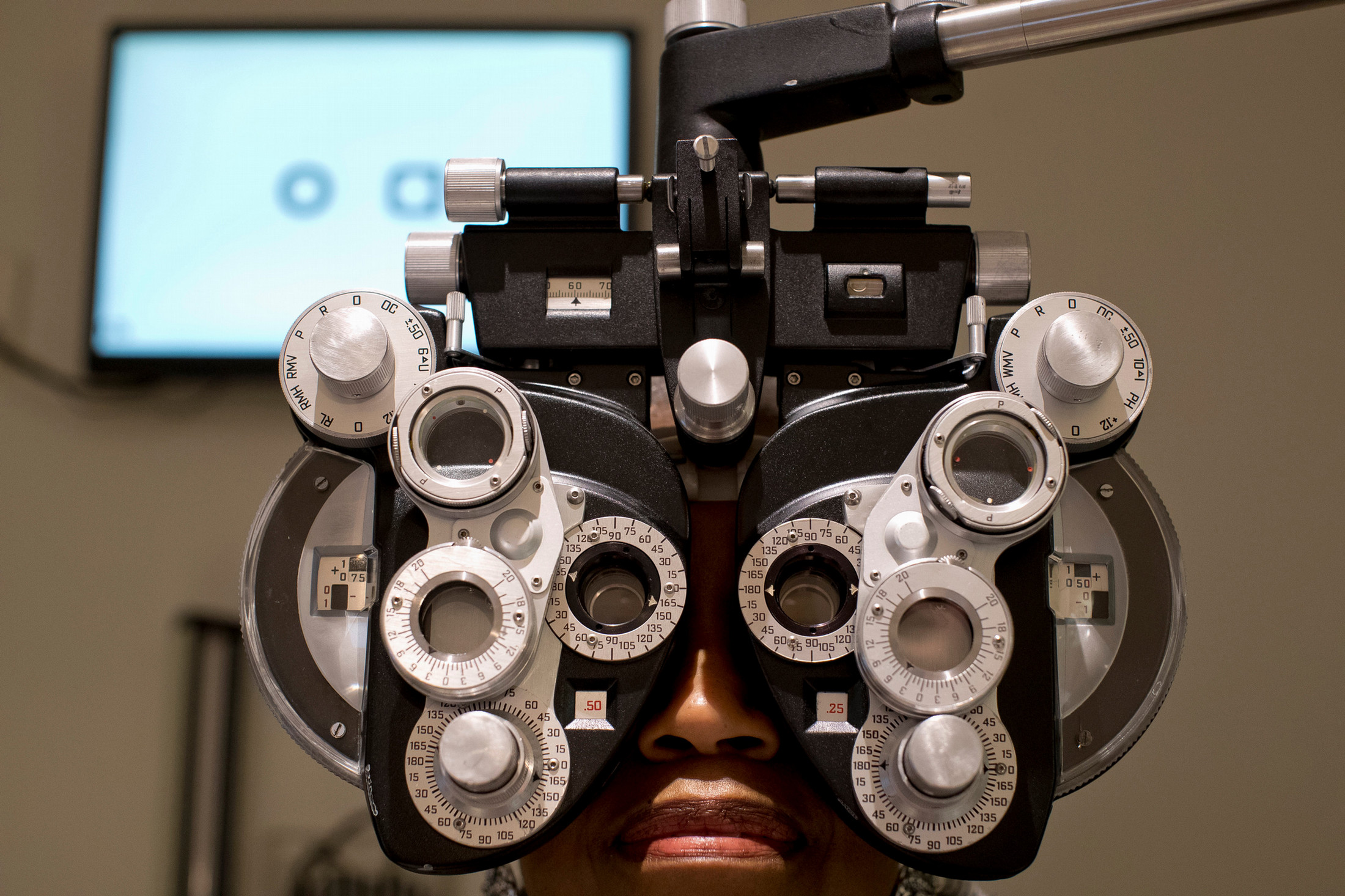 patient getting their eyes checked at the phoropter 