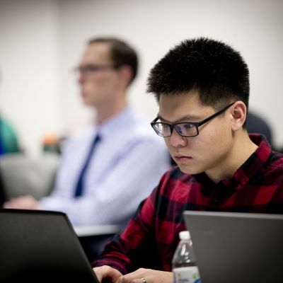 Image of a young man working at a computer