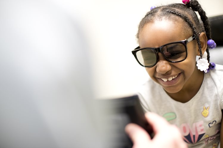 Young girl smiling wearing glasses