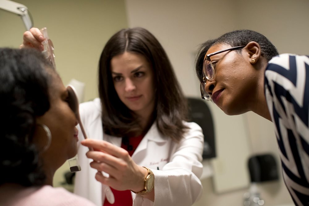 Optometrist examining patient