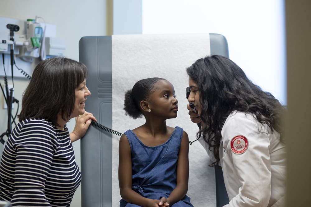 Optometry doctor conducting exam on child