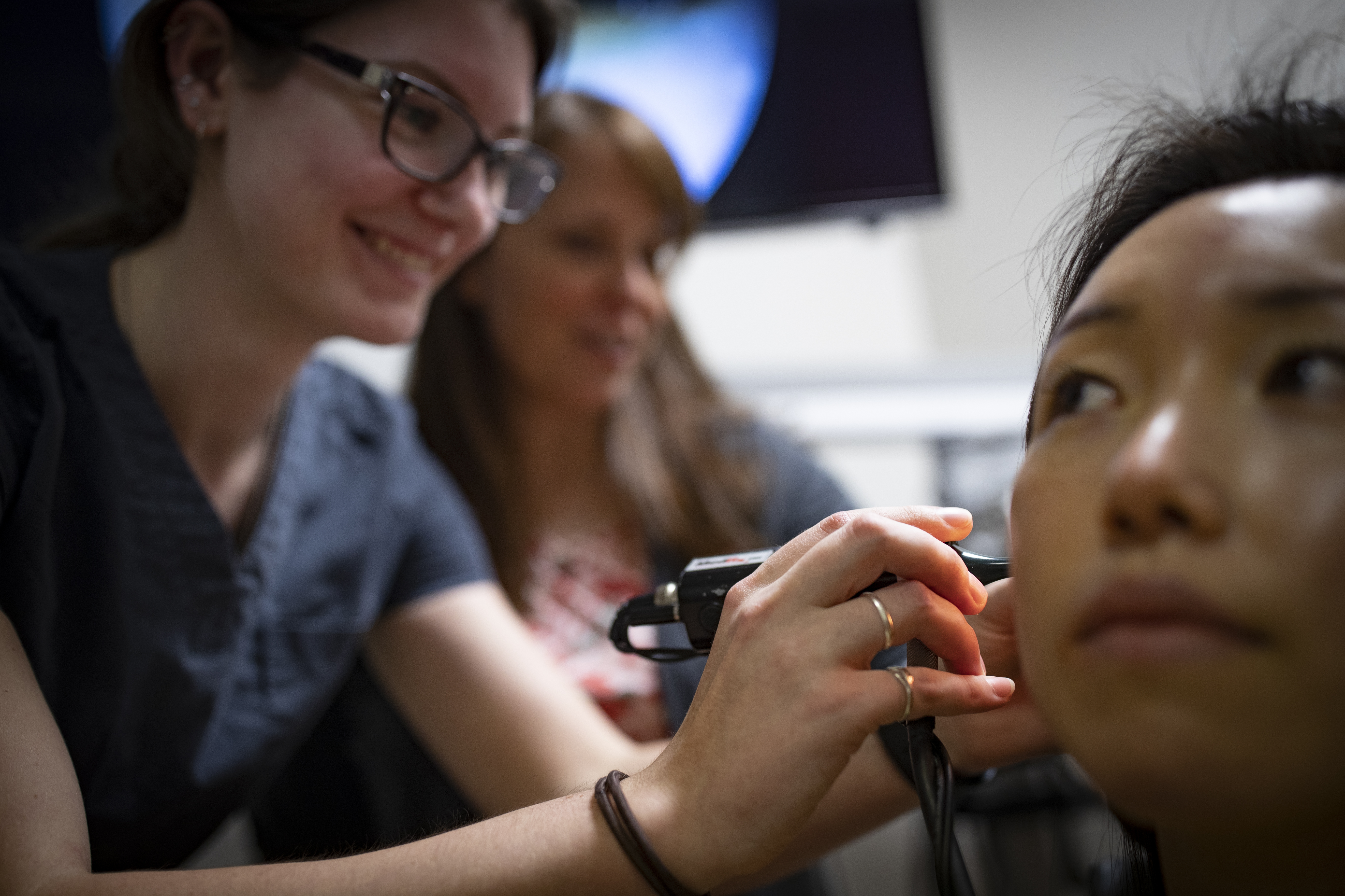 Woman having an ear exam