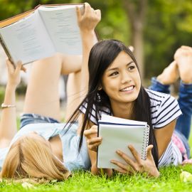 two young girls with notebooks