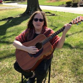 Amy Lustig playing guitar