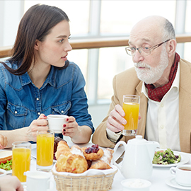 elderly man with younger woman