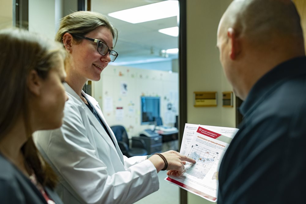 Audiologist reviewing hearing test with patient