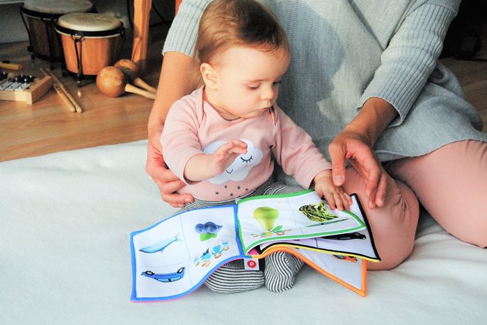 Baby playing with a book