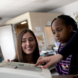 Audiology student conducting a screening on a pediatric patient