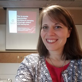 Dr. Bondurant selfie in front of her presentation