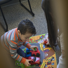 pediatric patient at SLI playing with toy truck