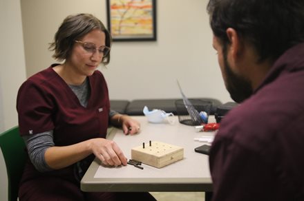 Brianna Brim working with a patient at OTI