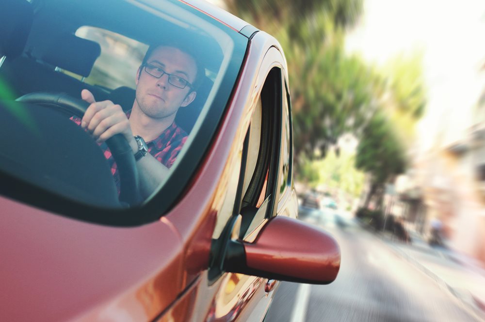 man driving a car