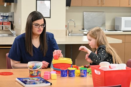 Child & OT working with blocks