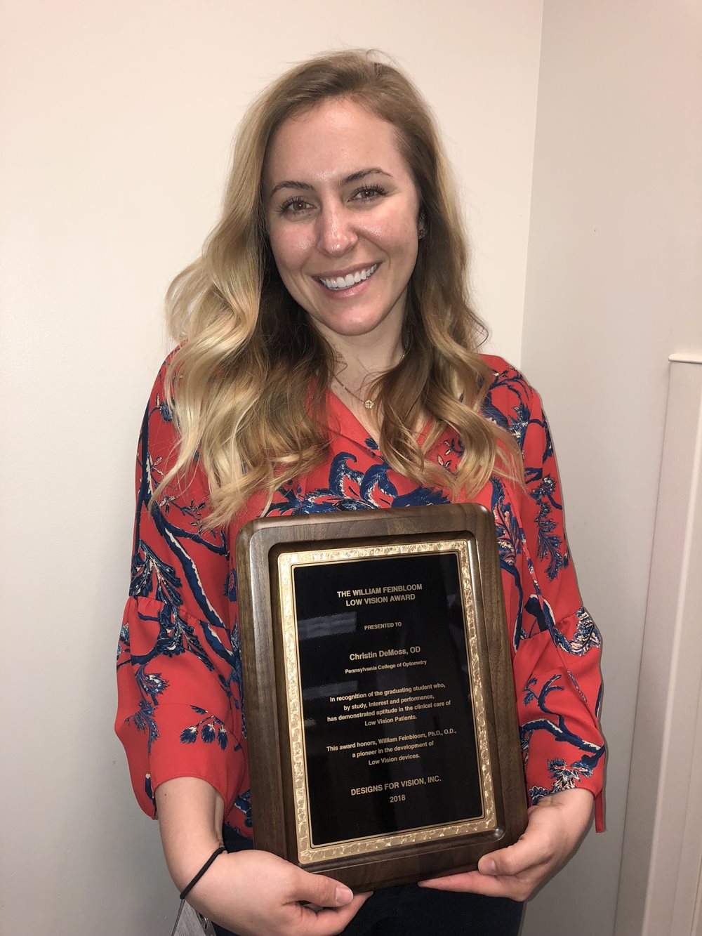 Dr. DeMoss holding her award