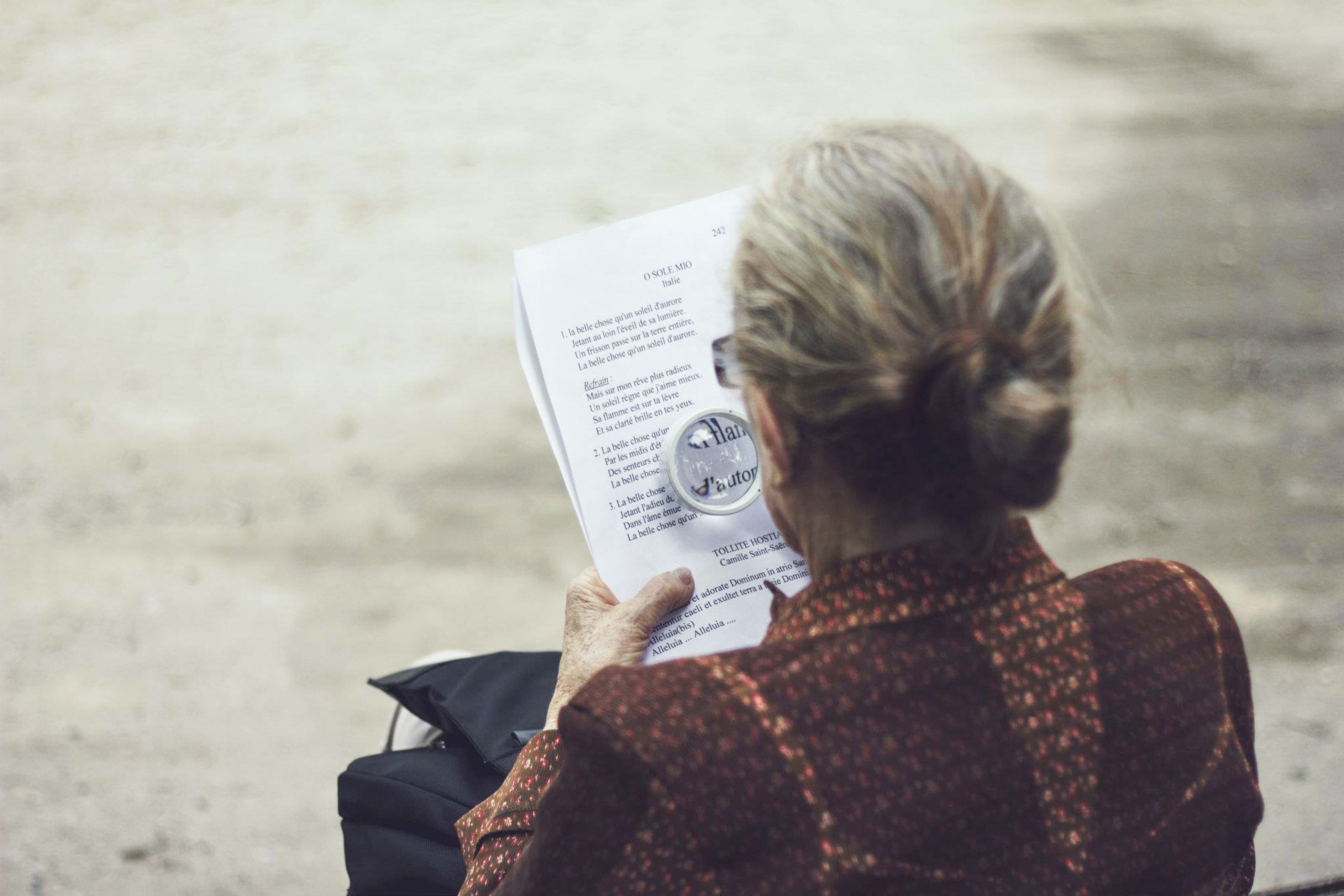 Older woman using a magnifying glass