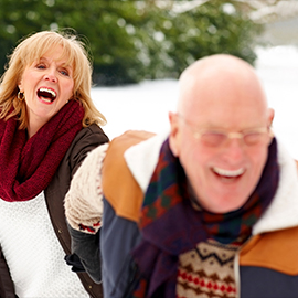 Older couple running in the snow