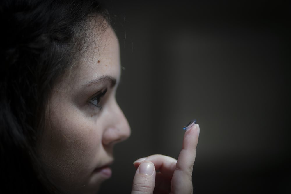 woman putting in contact lens