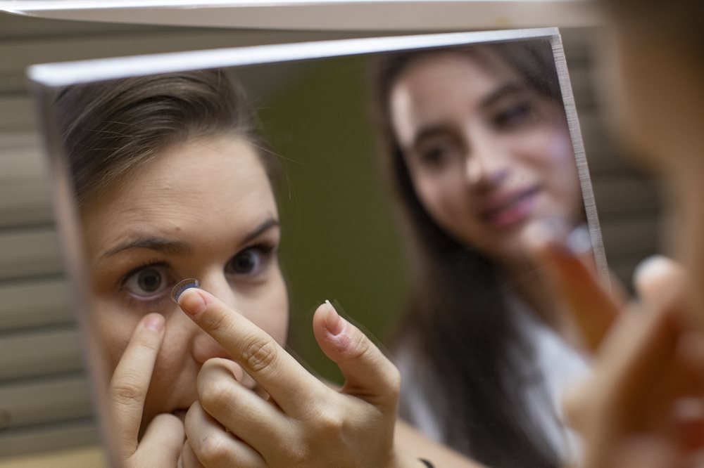 Woman putting in contacts