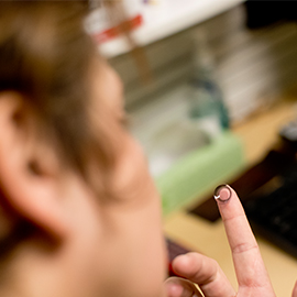 Person holding a contact lens