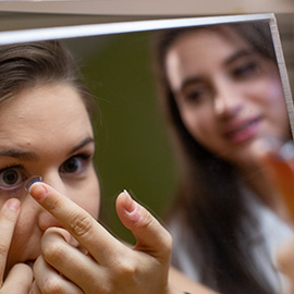 Woman putting in contacts