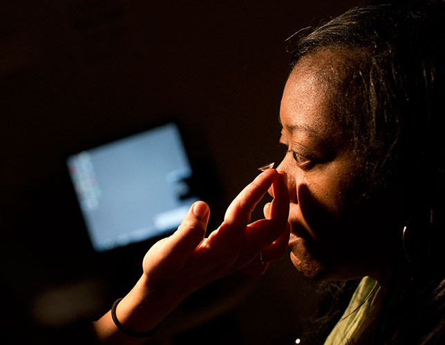 Person putting in a contact lens