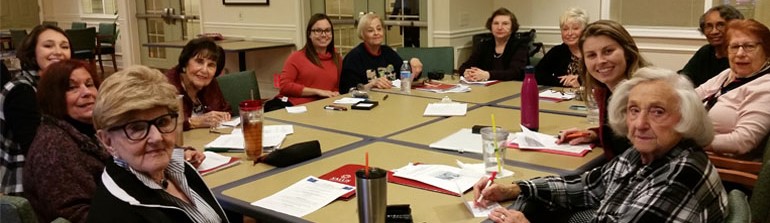 group sitting around a table making cards