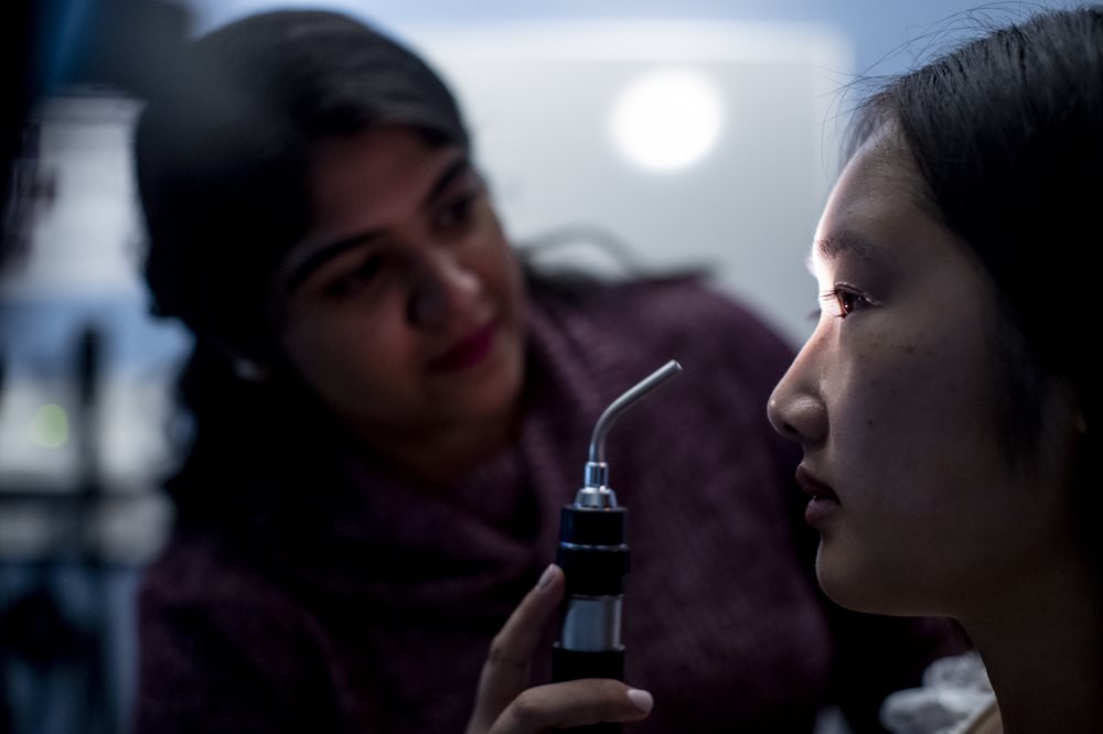 Optometrist examining woman