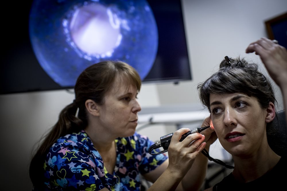 Woman having ear exam