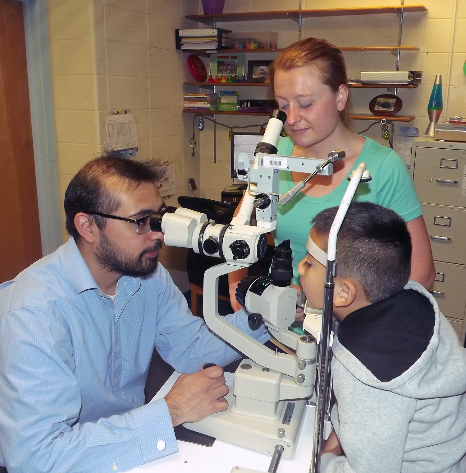 Dr. Luis Trujillo providing a vision exam to a pediatric patient