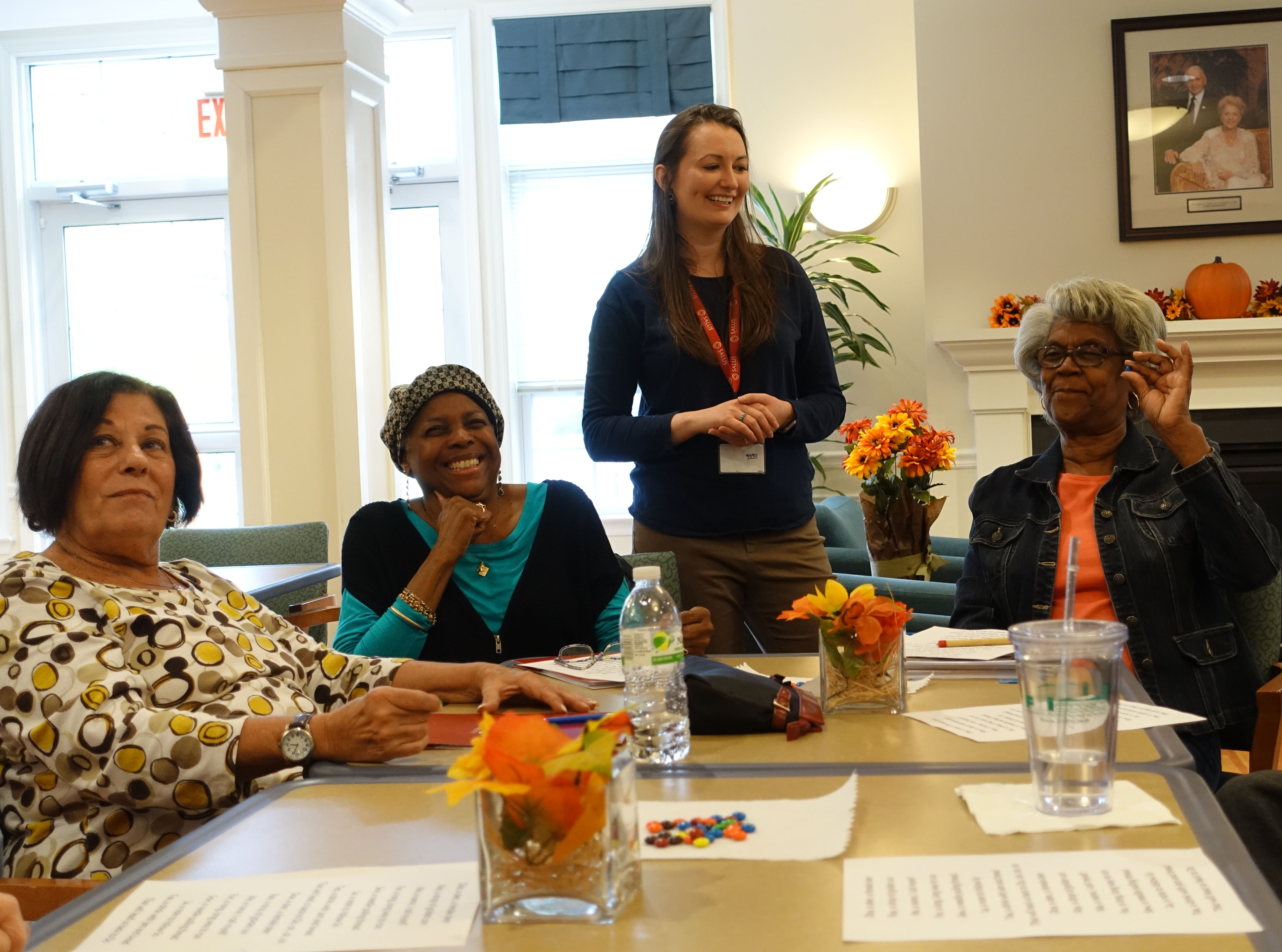 people sitting at a table smiling and laughing