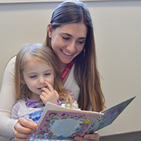 SLI clinician reading to pediatric client