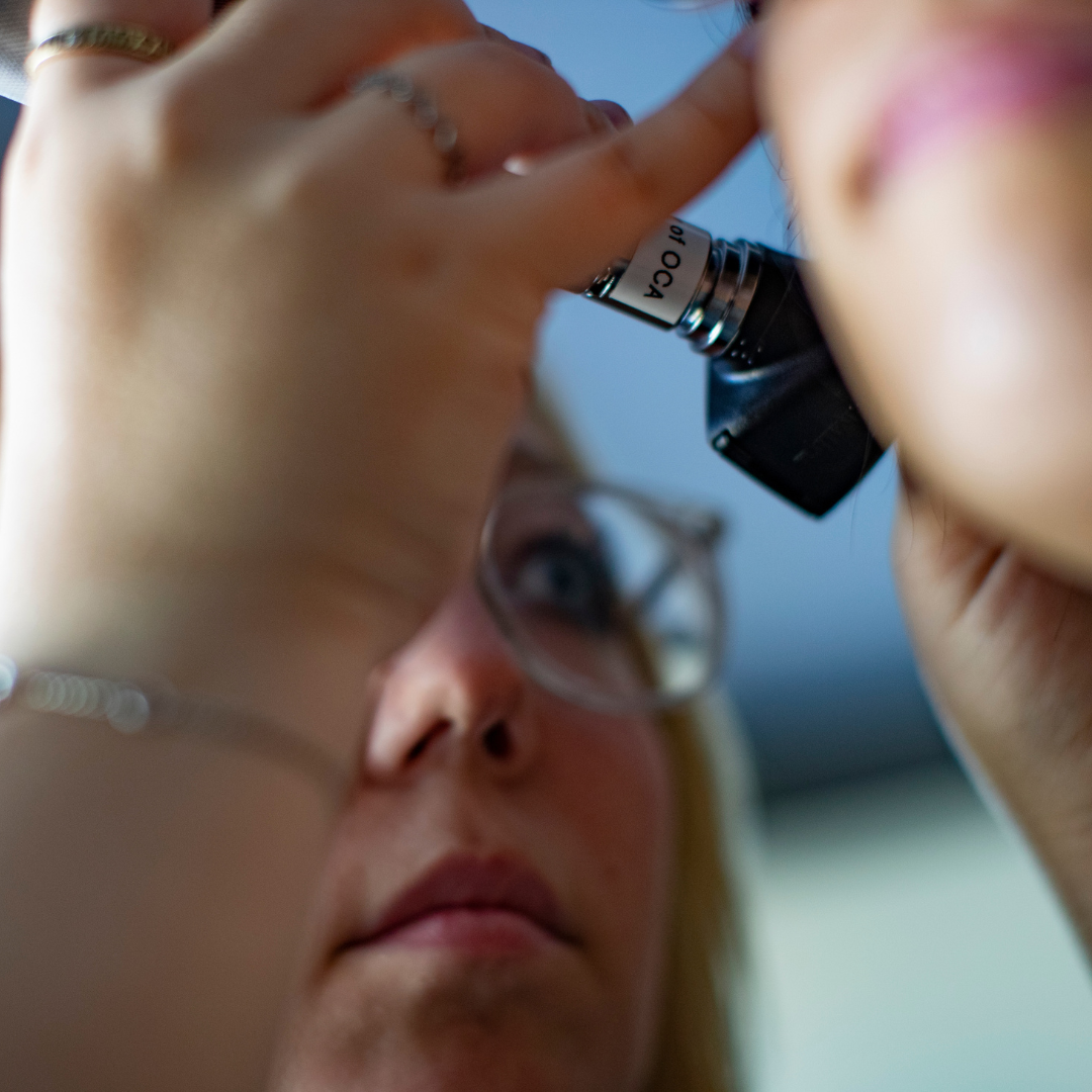 Audiologist checking the ear of a patient 