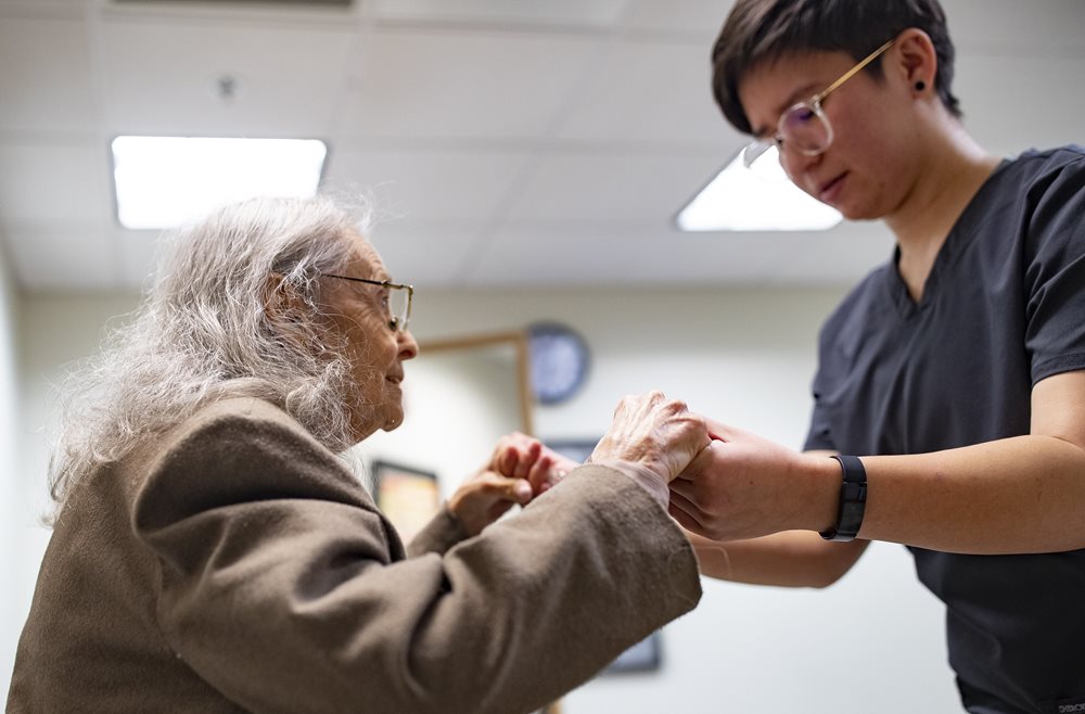 elderly woman working with OT student