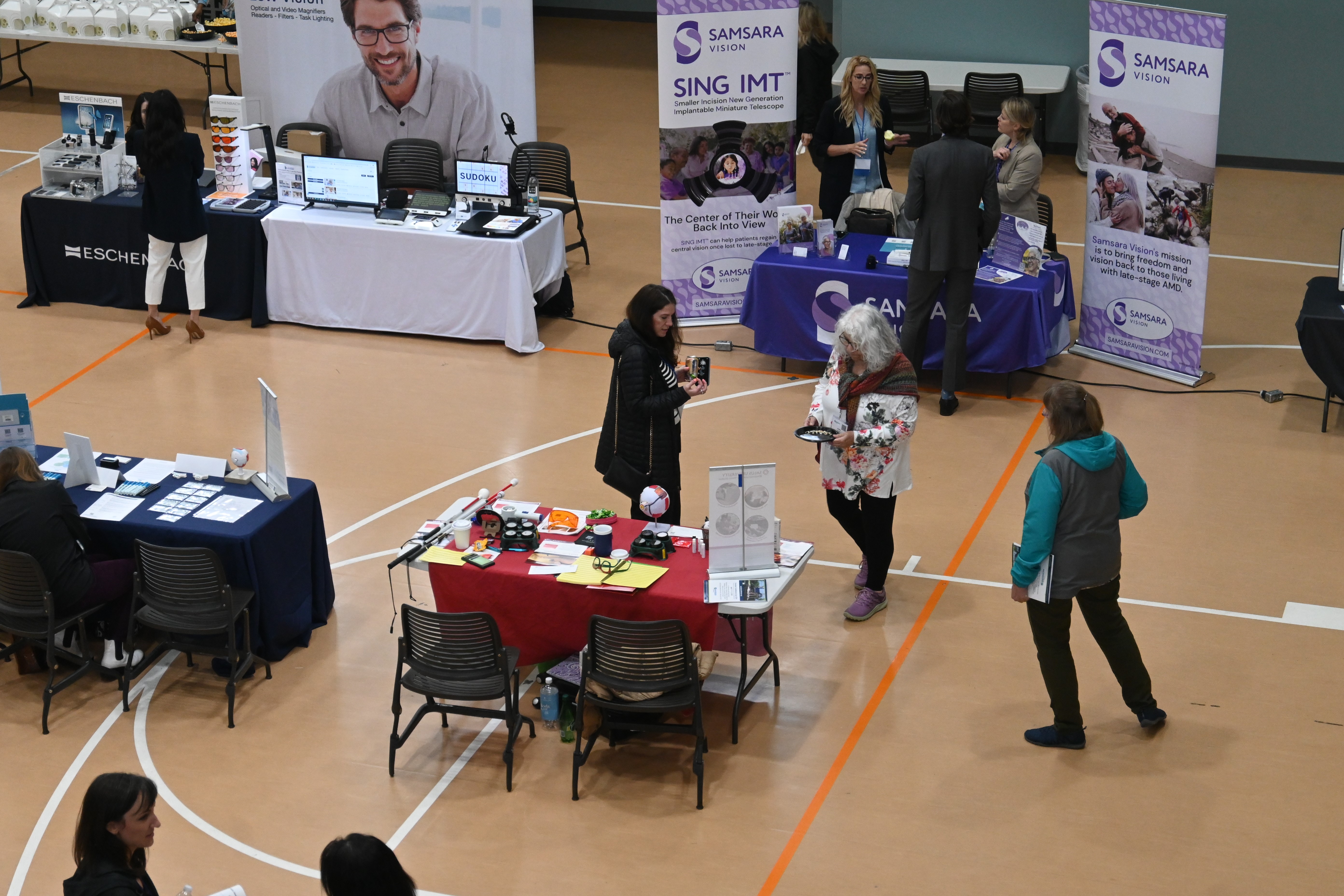 Envision Conference held in Salus community center with different booths showing different vision assistive devices 