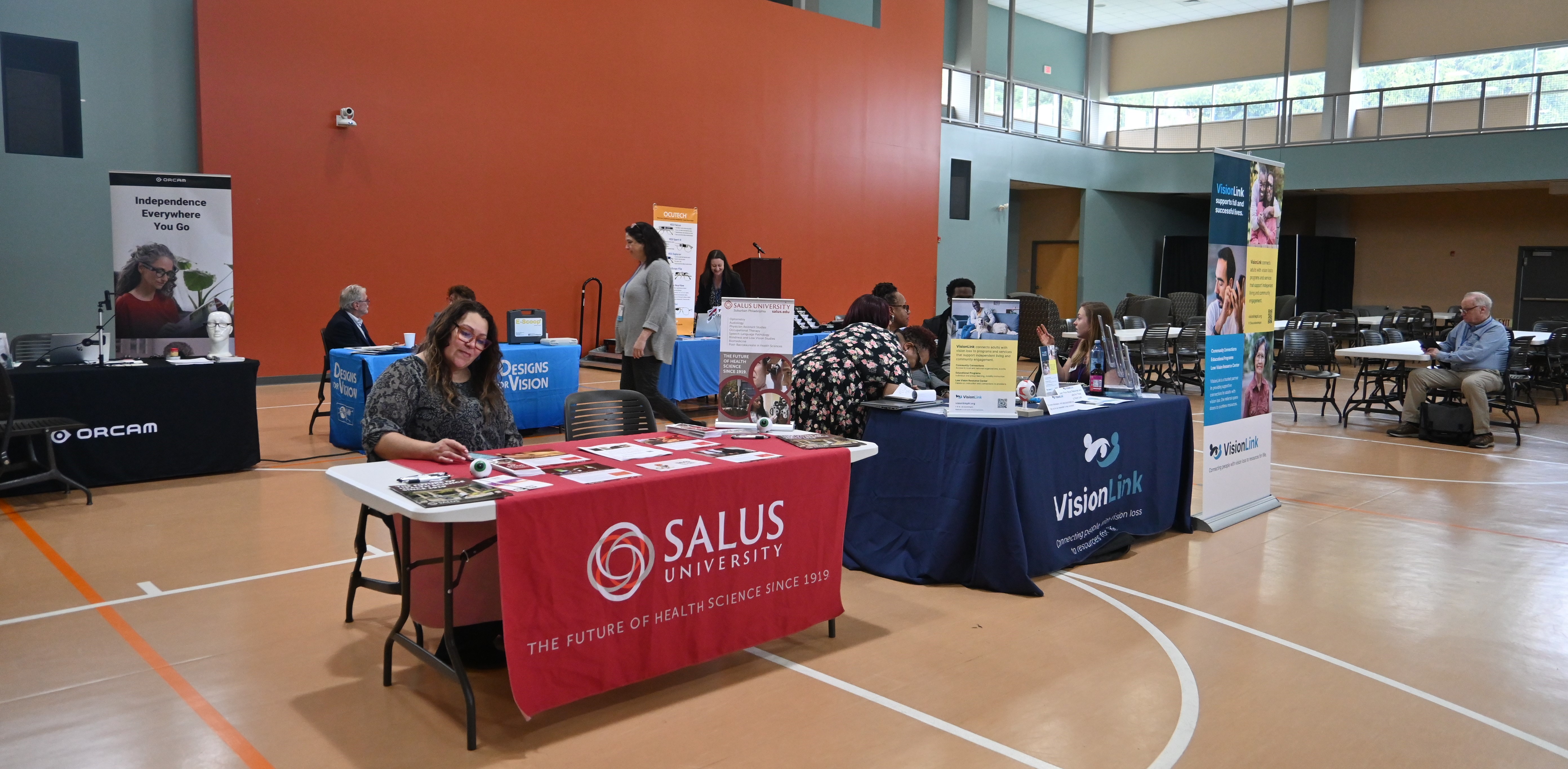 Envision Conference held in Salus community center with different booths showing different vision assistive devices 