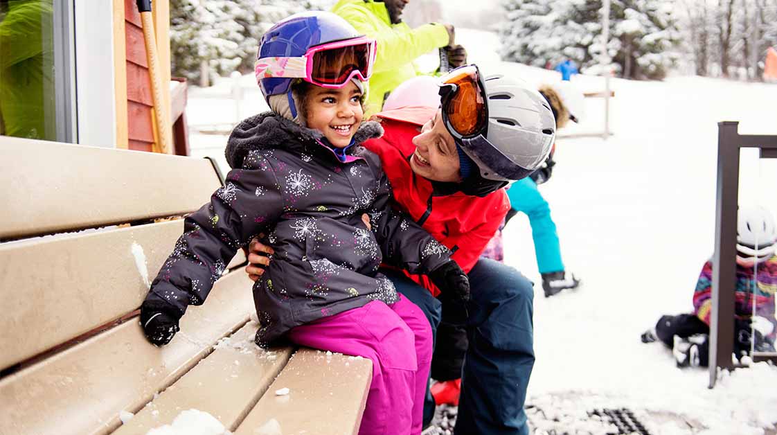 Mother and daughter snowboarding