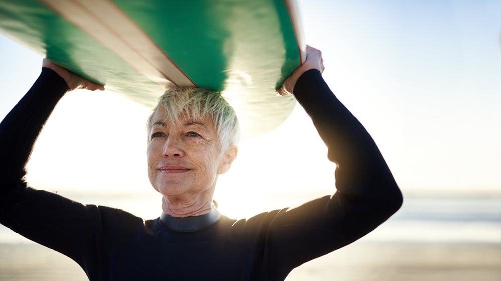 Woman holding a surfboard above her head