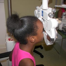 young girl having eye exam