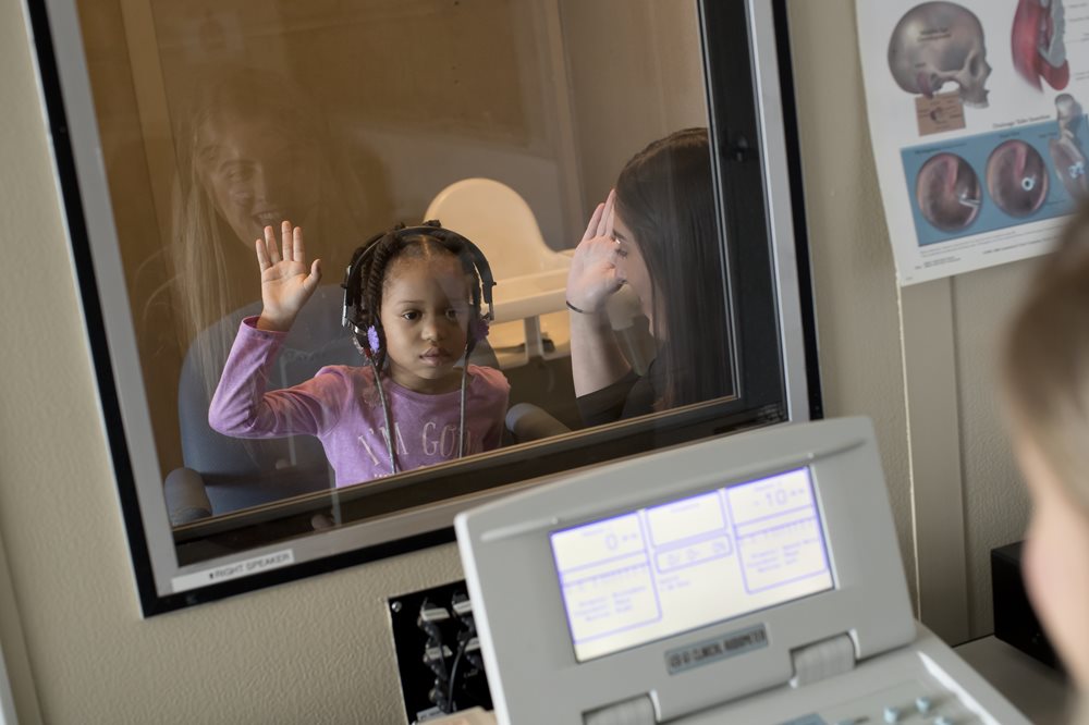 young girl having hearing test