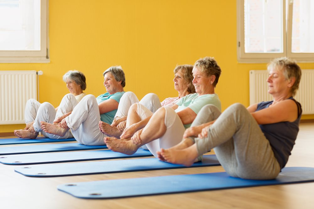 older women doing yoga