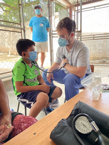 Salus students providing care to a young boy