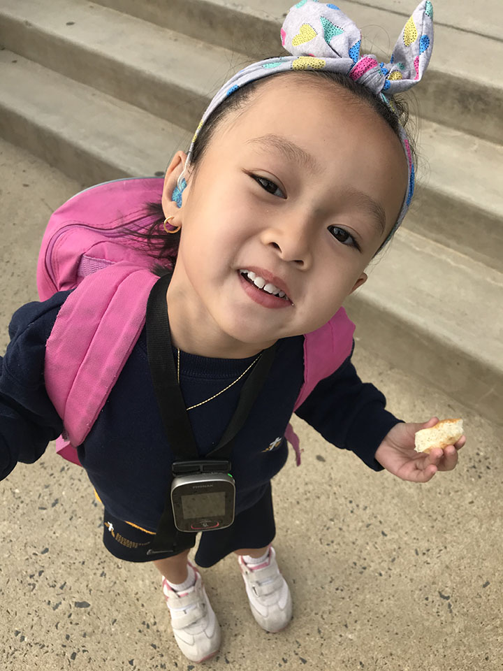 Young girl with hearing aid