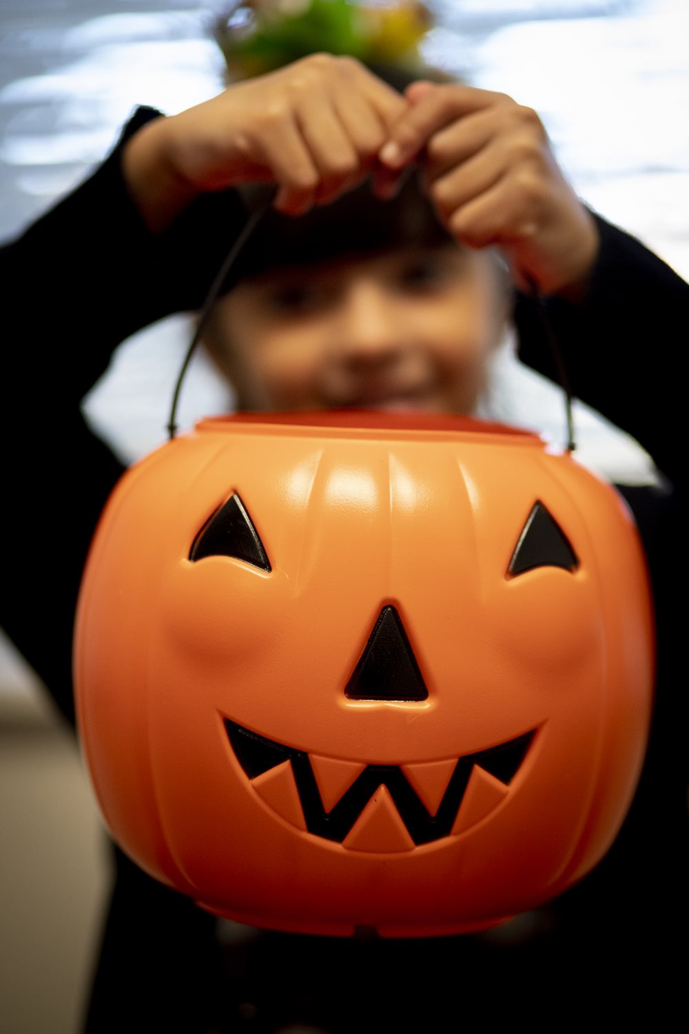 Little girl holding pumpkin basket