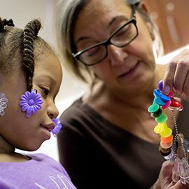 Dr. Owen working with a pediatric patient