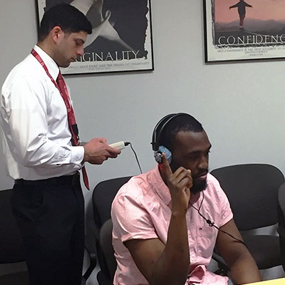 audiologist conducting hearing test