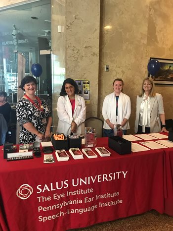 Audiology faculty and students at a Salus event