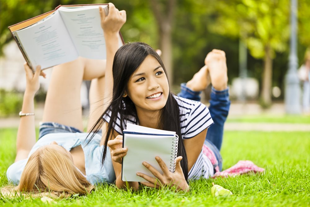 two women reading outside