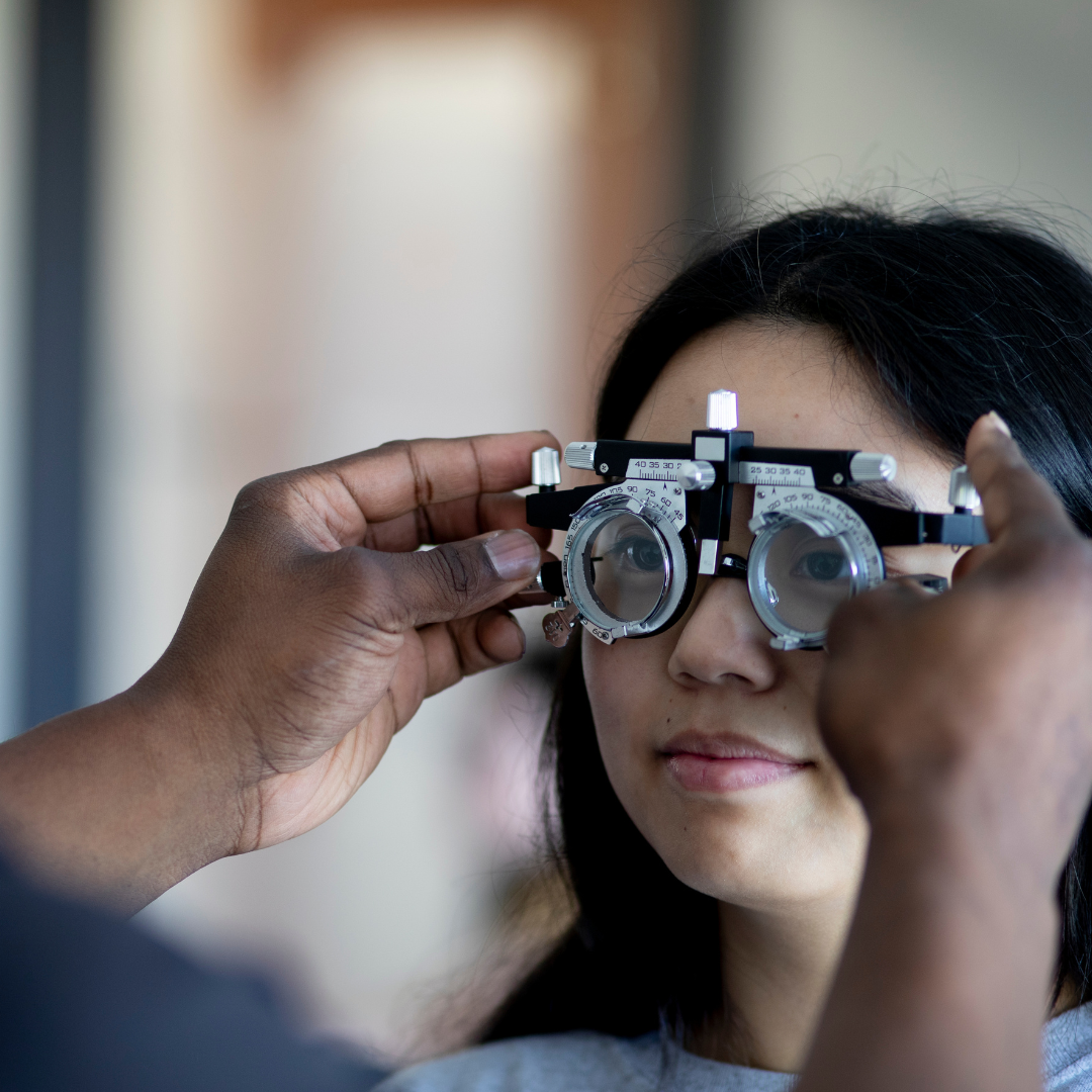 Women getting eyes checked with an optometry instrument 