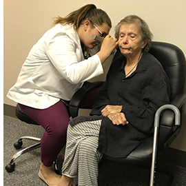 Senior citizen having hearing test